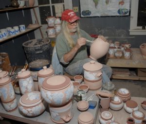 Terry Plasket decorating bisque ware pots
