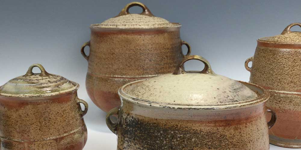 4 lidded wood fired, stoneware pots in natural brown