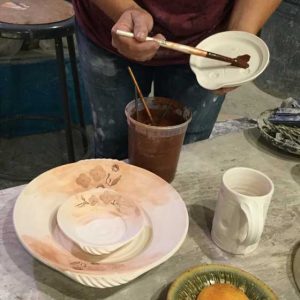 potter Applying-Iron-Oxide into the plant impression